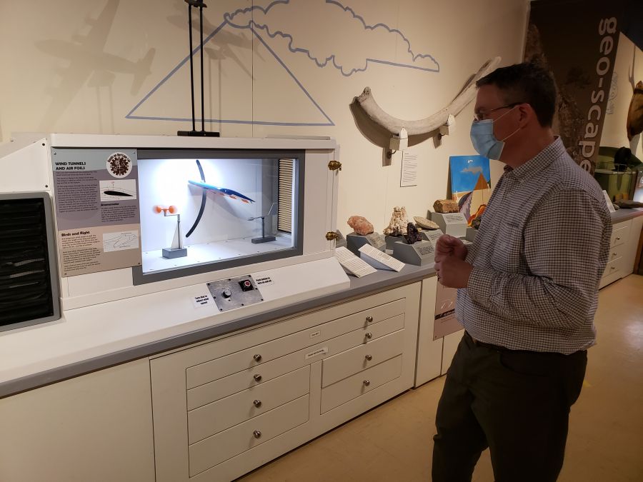 <who> Photo Credit: NowMedia </who> Penticton Museum Curator Dennis Oomen at the Wind Tunnels and Air Foil display.