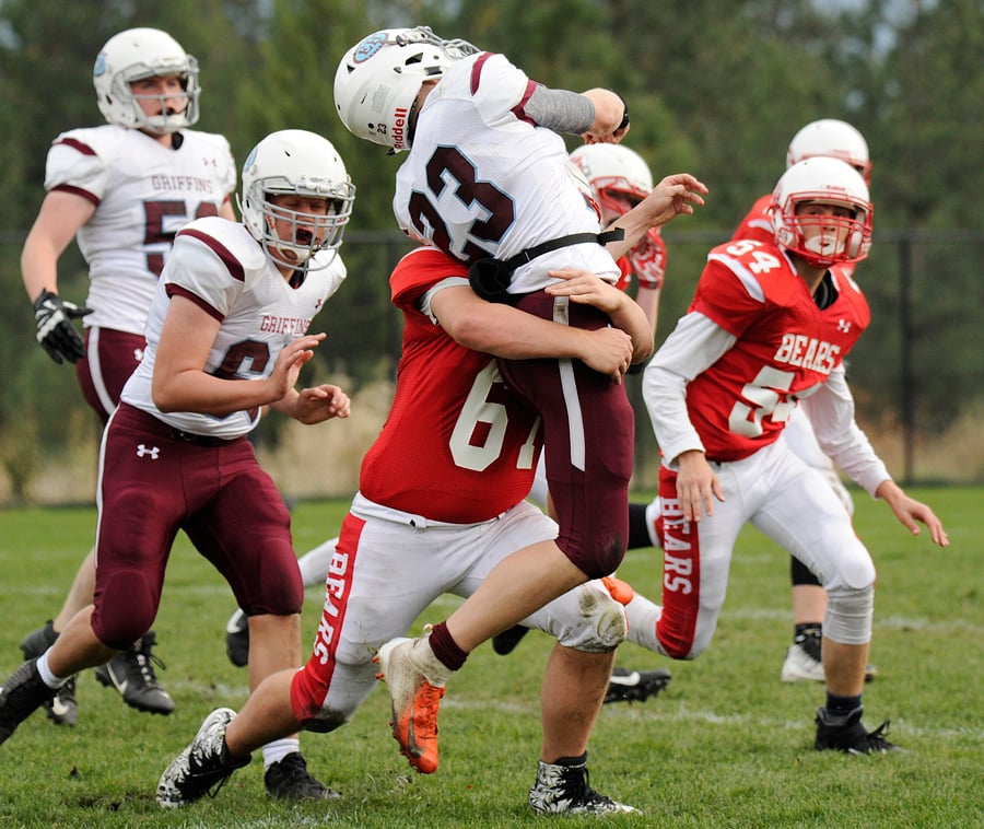 <who>Photo Credit: Lorne White/KelownaNow </who>The Mt. Boucherie Bears' Thomas Cronshaw lifts Eric Hamber Griffins' Josh Haegert off the ground just as the quarterback releases the ball in their Pacific Division game at Mar Jok Field. The Griffins went on to win the game 26-20.