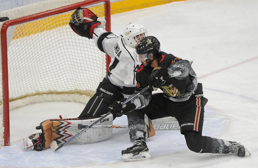 <who>Photo Credit: Lorne White/KelownaNow </who>Kyle Dumba of the Salmon Arm Silverbacks kicked out his leg to stop the Warriors' Parm Dhaliwal in the first period.