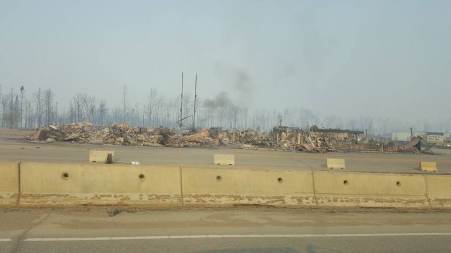 <who> Photo Credit: Geeven Chetty/Facebook. </who> Damage to one area of Fort McMurray has exceeded 80 per cent. 