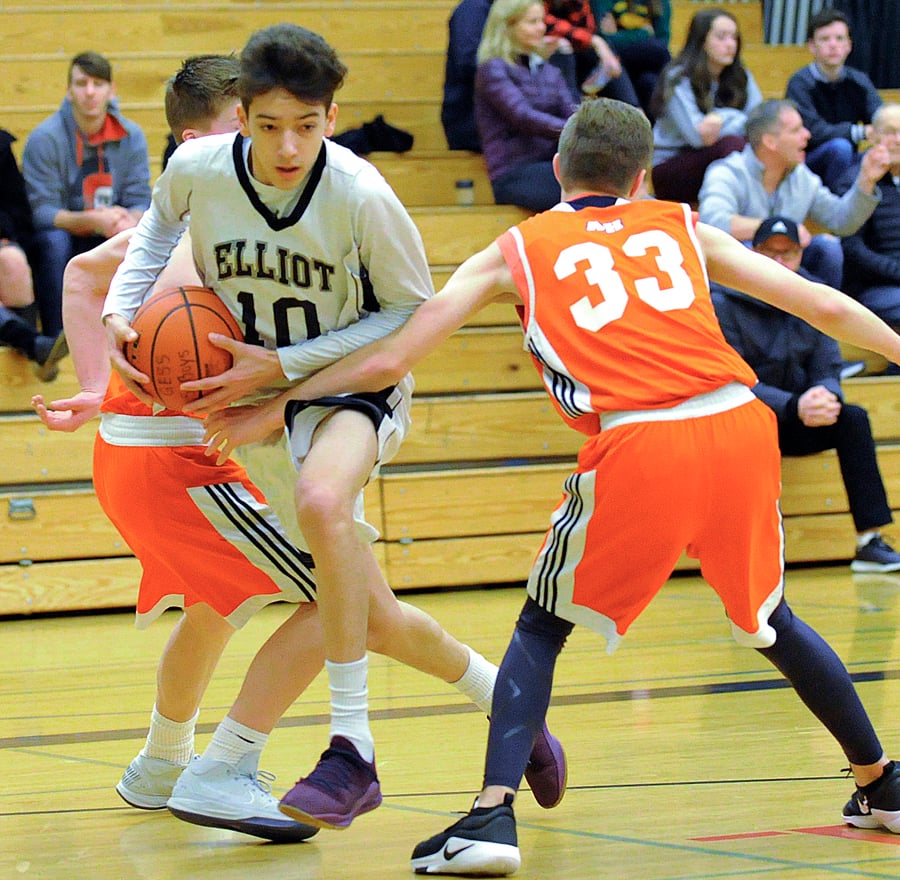 <who>Photo Credit: Lorne White/KelownaNow </who>Elliot's Carter Auger finds room between a pair of Aberdeen Hall defenders.