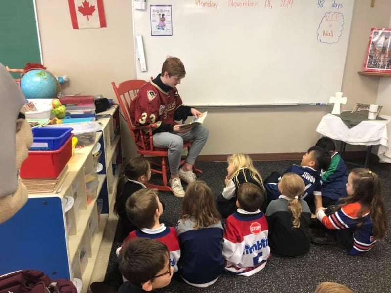 <who> Photo Credit: West Kelowna Warriors </who> Warriors players getting involved in school reading program.