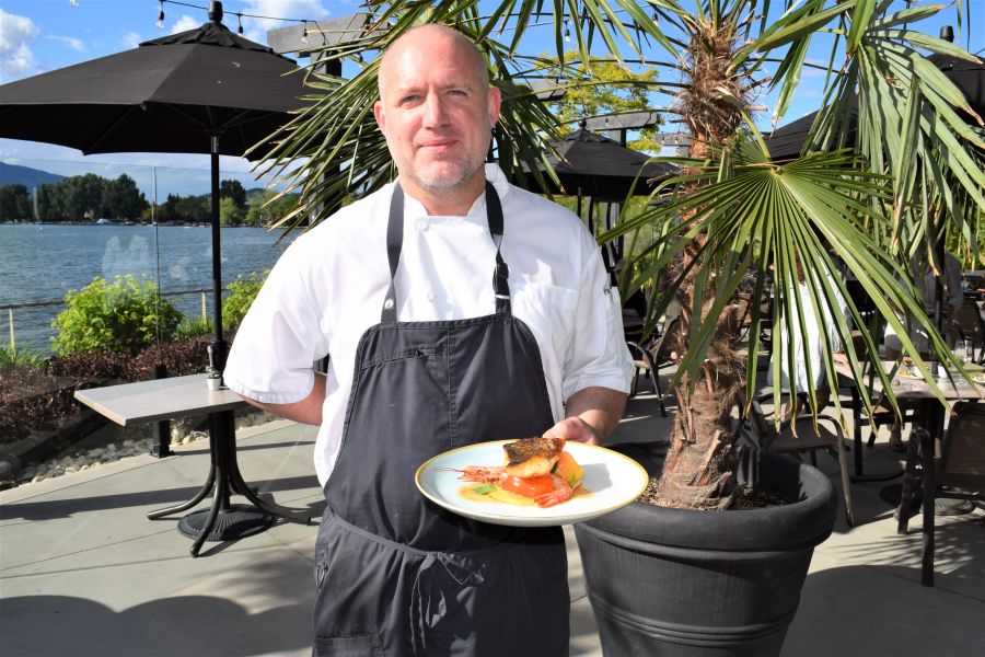 </who>Maestro's chef Jason Leizert shows off the roasted seabass on the palm-treed patio.