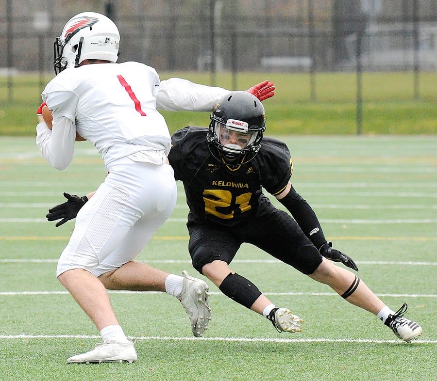 <who>Photo Credit: Lorne White/KelownaNow </who>Kieran Koltun of the Owls defends on the Eagles' James Curleigh. Koltun scored a pair of touchdowns for the Owls.