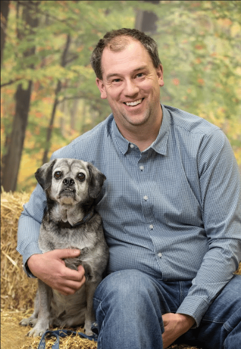 Dr. Rand Davis and their Pug/Cocker Spaniel mix, Oscar