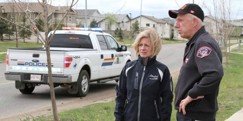 <who> Photo Credit: Royal Canadian Mounted Police in Alberta. </who> Alberta Premier, Rachel Notley, on an escorted tour of Fort McMurray.