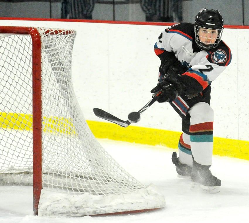 <who>Photo Credit: Lorne White/KelownaNow </who>The Rockets' Brett Lesowski clears the puck out of harm's way in a round-robin game with Whistler.