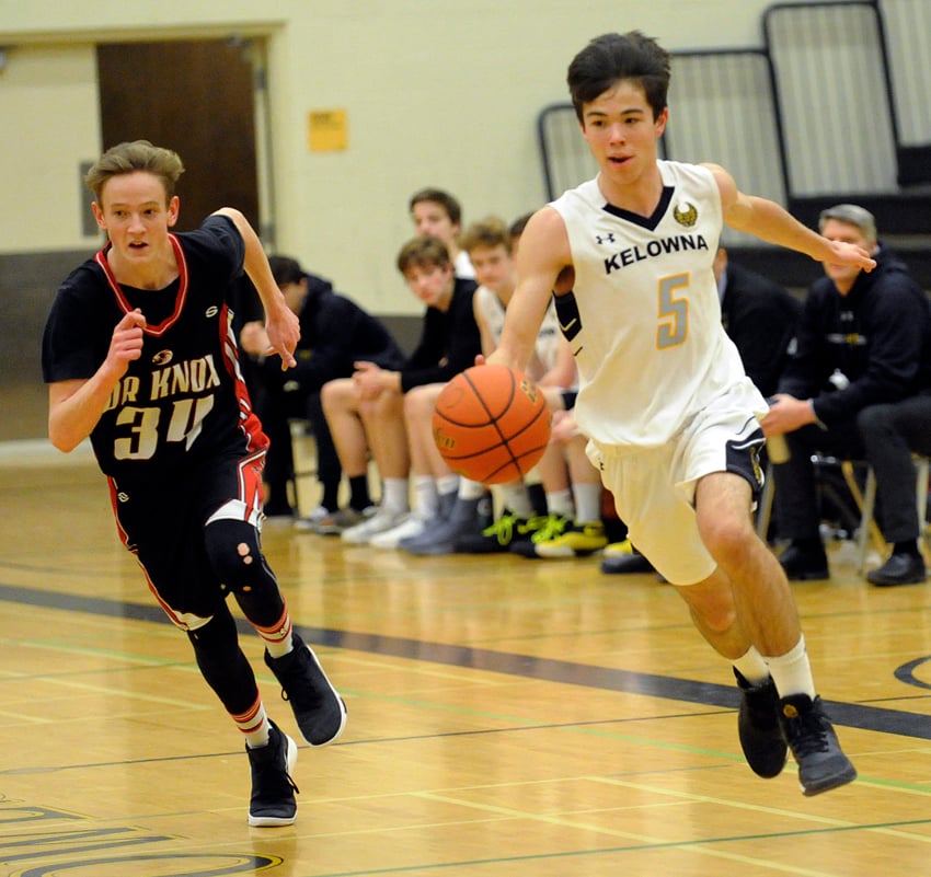 <who>Photo Credit: Lorne White/KelownaNow </who>Braden White, right, driving against the Dr. Knox Falcons in semifinal play, scored 16 points in the KSS Owls' zone championship win over the Boucherie Bears.