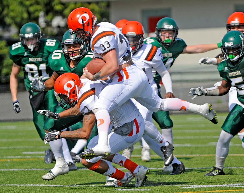 <who>Photo Credit: Lorne White/KelownaNow </who>Brenden Hansen attempts to leap over teammate Rashaun Simonise during the Sun's march to a touchdown early in their win in Chilliwack.