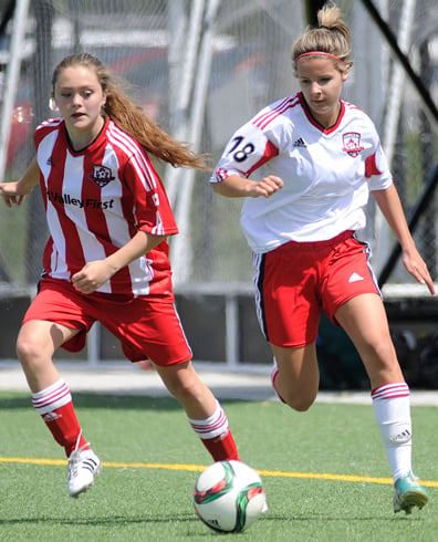 <who>Photo Credit: Lorne White/KelownaNow </who>Tiernan Hickson, left, of the United U15s and United U16s' Sierra <br>Young race for possession at Mission Stadium. 