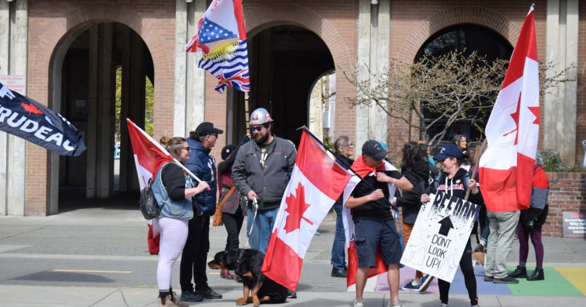 Anti-Trudeau protesters gather outside Victoria city hall during PM’s meeting with Mayor Lisa Helps