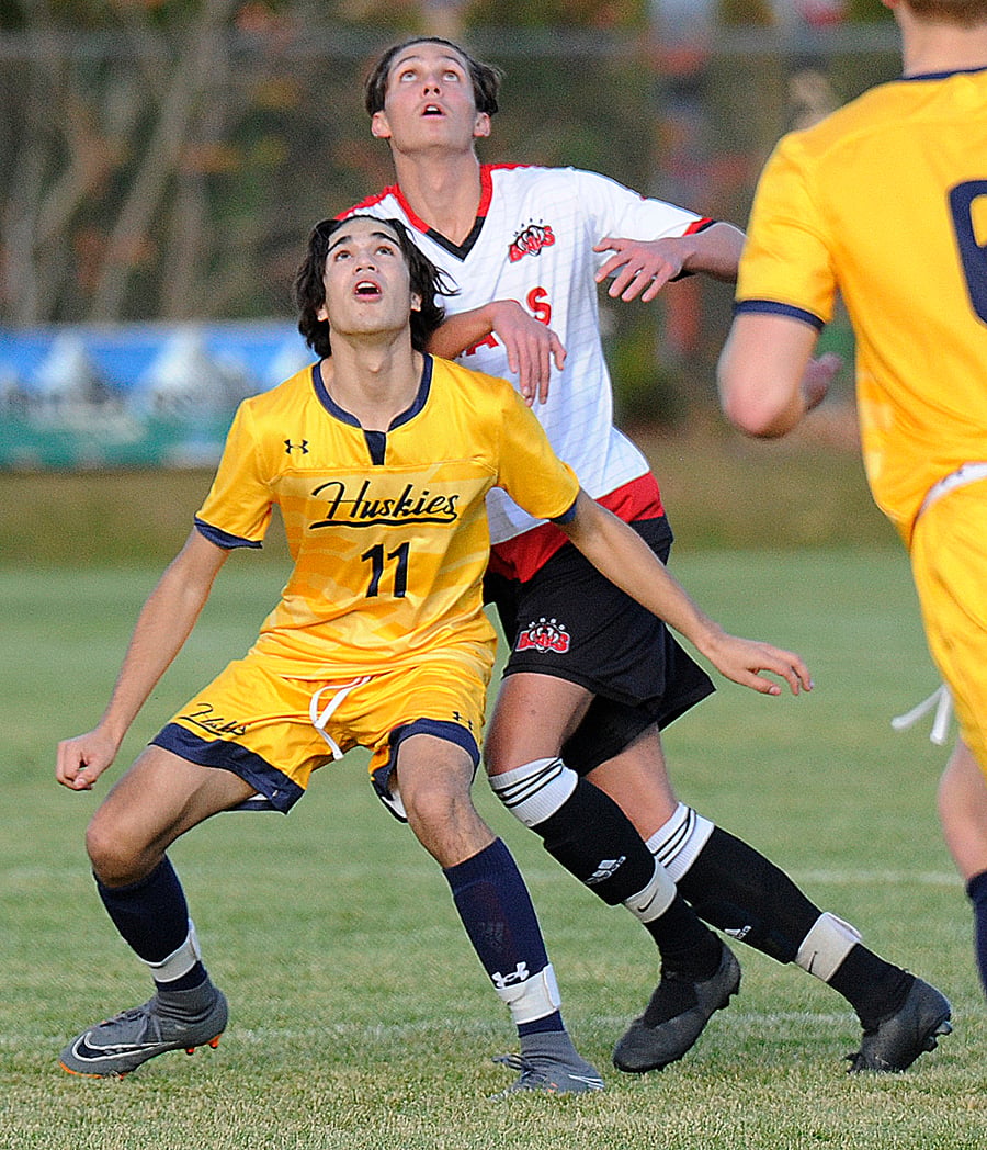 Waiting to make a play on a lofted ball: Brandon Nemes of OKM, left, and Attila Kneider of the Bears.