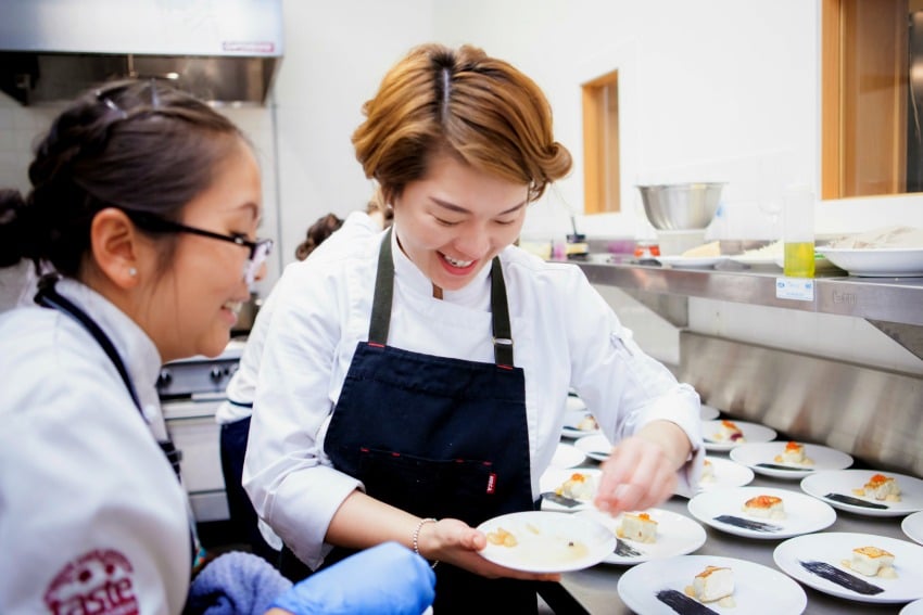 <who> Photo Credit: Thuy Tran Photography </who> Chefs, Tina Tang and Jinhee Lee plating Aman’s second course 
