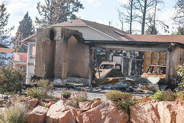 <who> Photo Credit: KelownaNow. </who> One of eight homes destroyed in the Okanagan Centre wildfire.