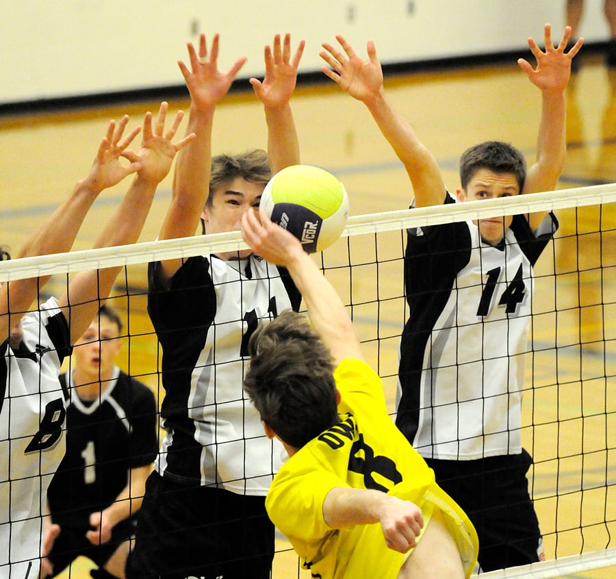 <who>Photo Credit: Lorne White/KelownaNow </who>Jayden Lalonde of the KSS Owls with not much room to hit the ball through the George Elliot defence of, from left, Jordan Baker, Bergen Van Lent and Austin Duff.