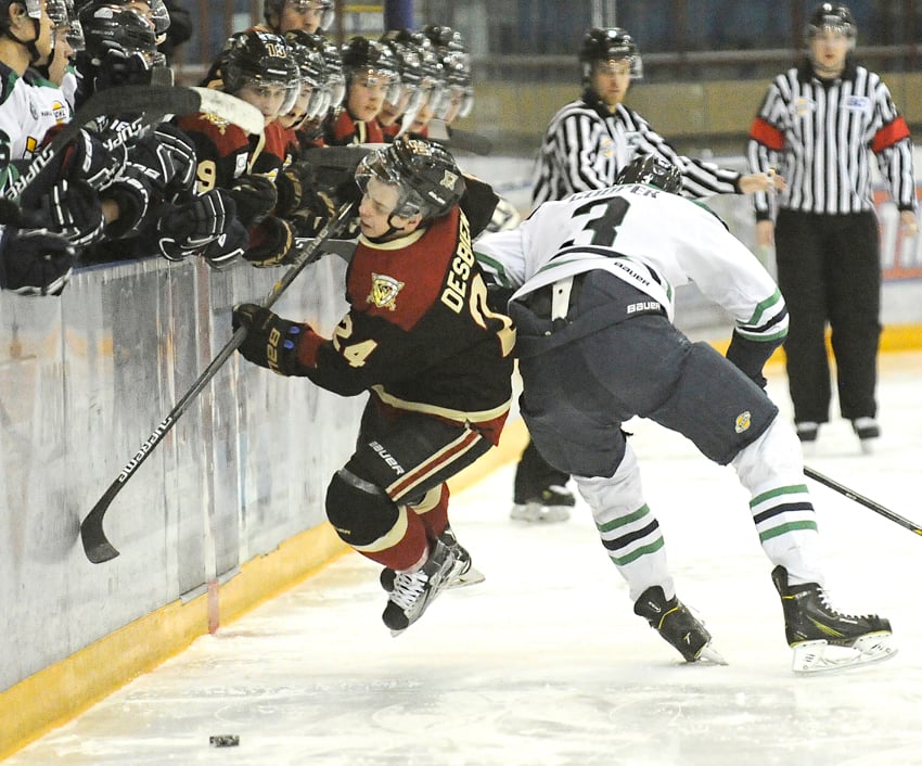 <who>Photo Credit: Lorne White/KelownaNow </who>Tyler Cooper of the Surrey Eagles gets a piece of the West Kelowna Warriors' Jonathan Desbiens, enough bring him down near centre. Desbiens went on to score his 24th goal of the season and assisted on another Warriors marker in a 7-2 BCHL victory.