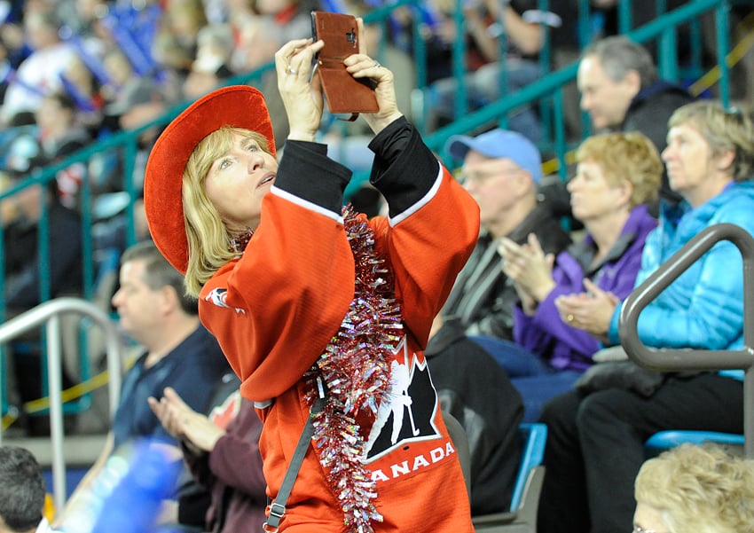 <who>Photo Credit: Lorne White/KelownaNow.com </who>A hockey mom from Kelowna captures memories for the Kelowna bantam A girls team at the Sandman Centre in Kamloops.