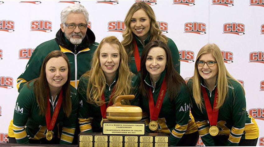 <who>Photo Credit: Ken Reid/Greystoke Photography </who>The Kesley Rocque rink of the University of Alberta display their gold medals and CIS championship trophy.