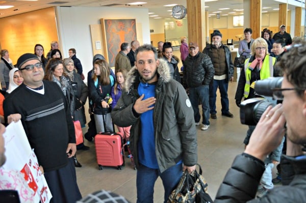 <who> Photo Credit: KamloopsBCNow </who> Mohamad Almousa being welcomed by the community of Kamloops at the airport.