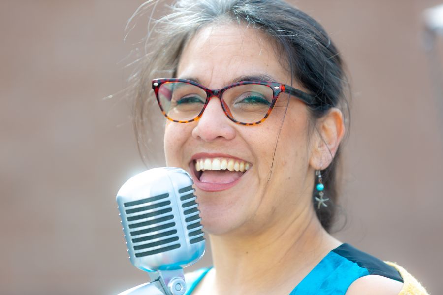 <who>Photo Credit: NowMedia/Gord Goble</who> Yanti at the mic