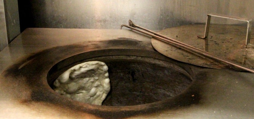 <who> Photo Credit: KelownaNow </who> This traditional charcoal oven was brought over from India to prepare the perfect naan.