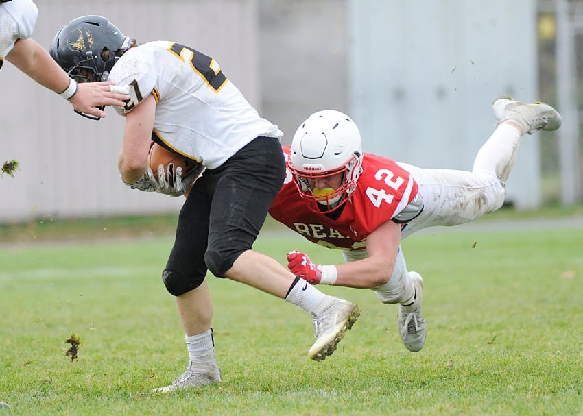 <who>Photo Credit: Lorne White/KelownaNow </who>Chayton Nidd of the Boucherie Bears makes a flying tackle on the Owls' Kenny Clarke.