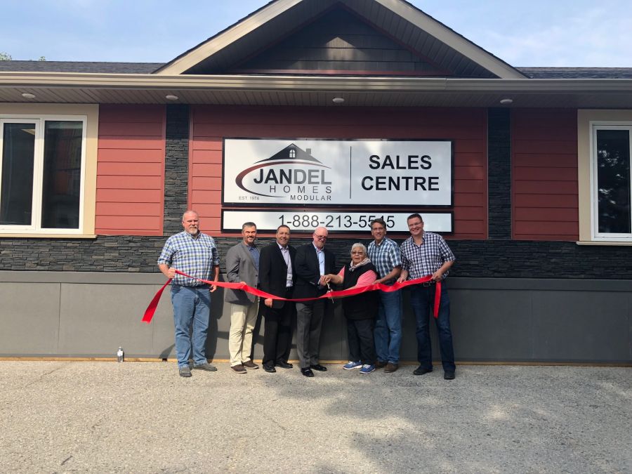 <who>Photo Credit: Contributed </who>Jandel Homes Ltd. president and CEO Mark Huchulak (centre glasses) was joined by members of his sales staff as well as local MP Dan Albas (second from right) and Penticton Mayor Andrew Jakubeit for the official ribbon cutting ceremony Wednesday afternoon.