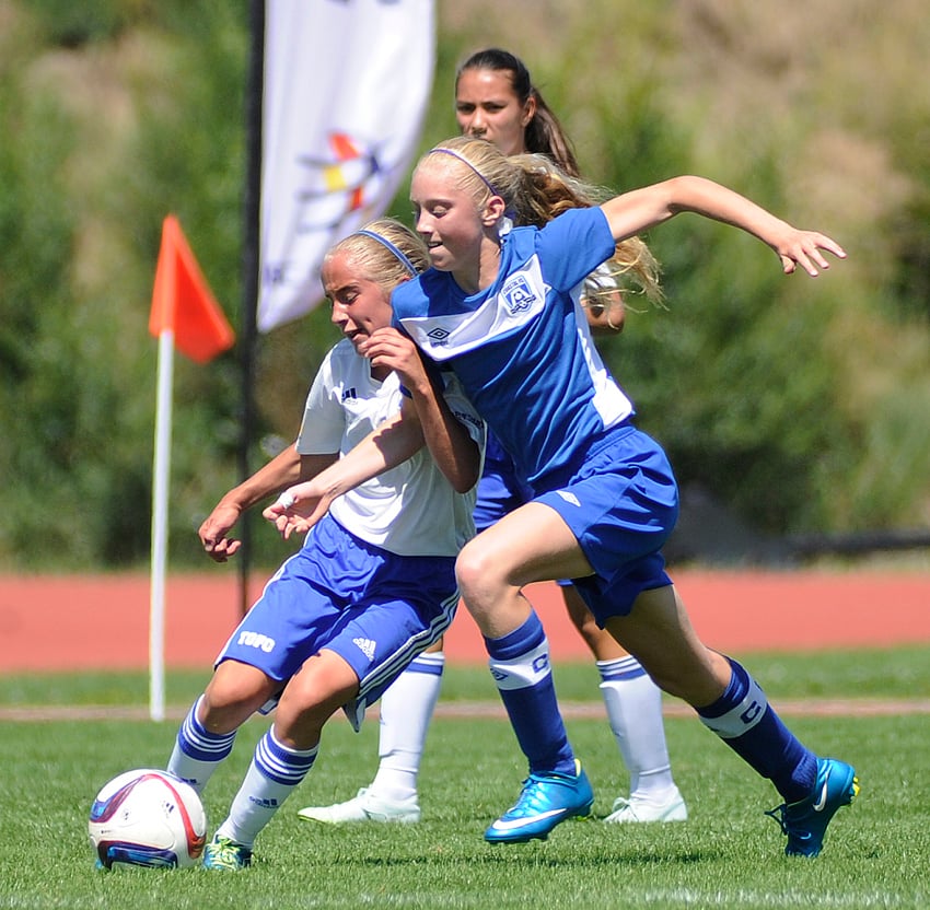 <who>Lorne White/KelownaNow </who>Annika Gross, left, of the TOFC fends off a Coastal FC check to pass the ball to a teammate in the first half.