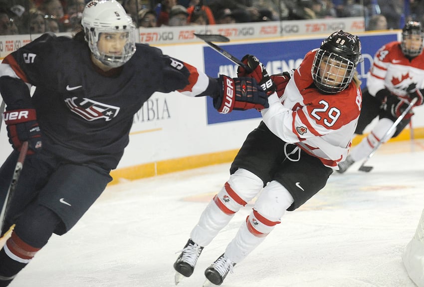 <who>Photo Credit: Lorne White/KelownaNow.com </who>Canadian captain Marie-Philip Poulin stays stride for stride with U.S. defenceman Megan Keller.