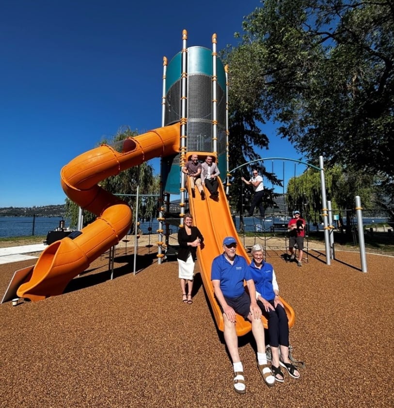 <who>Photo Credit: City of Kelowna</who>Mayor Tom Dyas, Councillors Loyal Wooldridge, Luke Stack and Ron Cannan, KGH Foundation CEO Allison Young and Kiwanis Legacy Fund Committee Members Tom Cockrell and Wendy Falkowski test out the new playground.