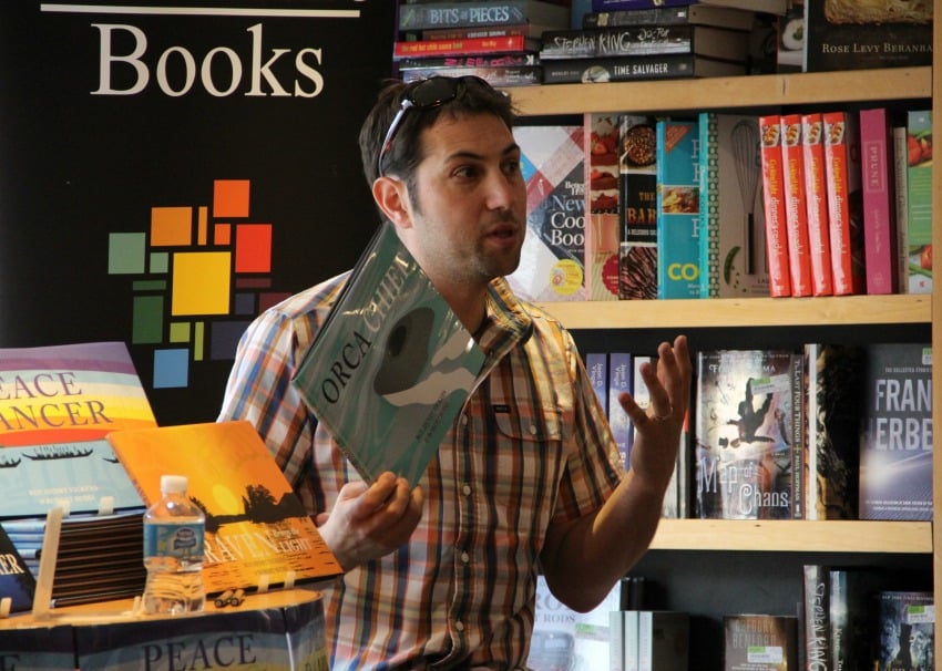 Budd speaking to the crowd at Mosaic Books in Kelowna.