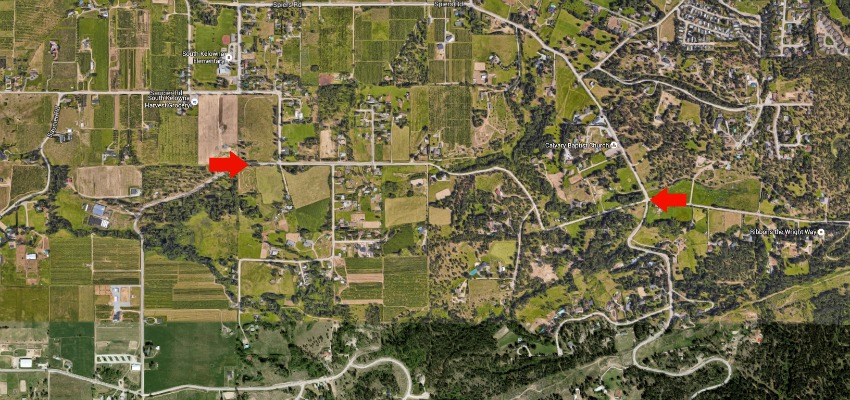 <who> Photo Credit: Google Earth </who> The red arrows indicate the Mathews Road in south-east Kelowna. 
