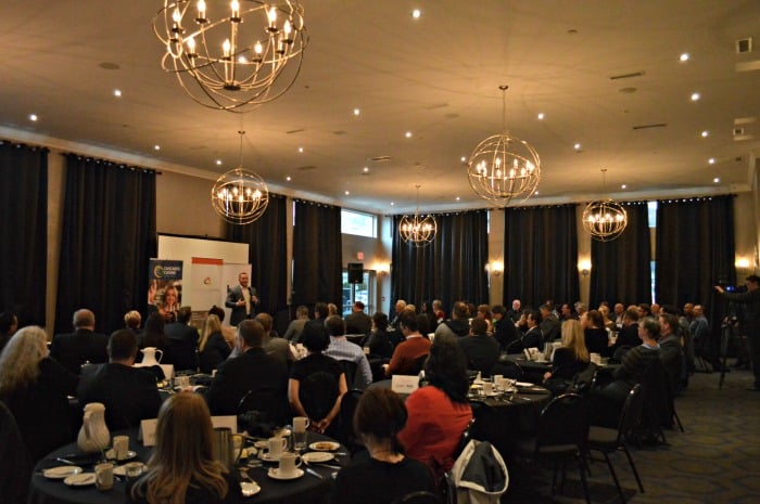 <who> Photo Credit: KamloopsBCNow </who> Former CFL player Angus Reid shared his story at a Kamloops Chamber of Commerce Luncheon at the Sandman Signature on Tuesday.