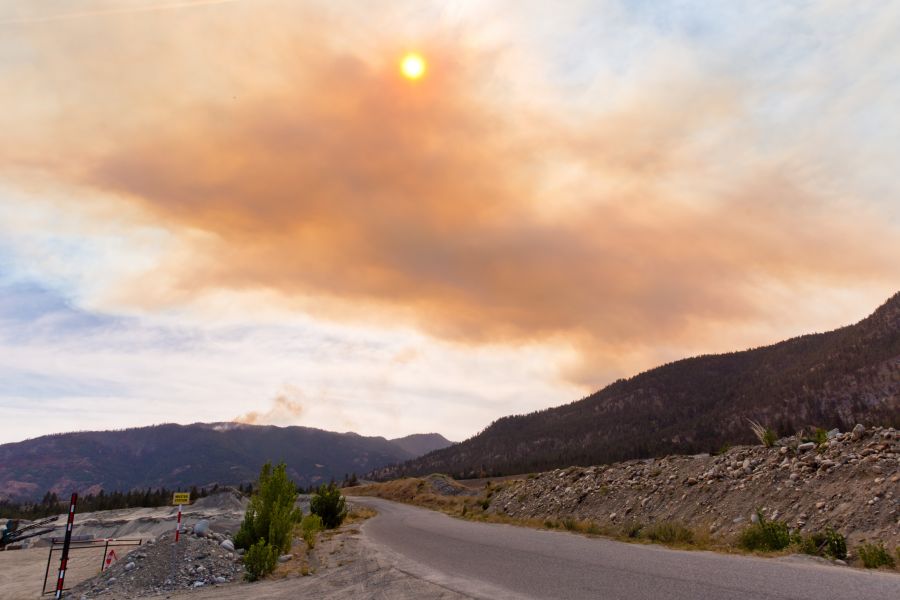 <who>Photo Credit: NowMedia</who>Smoke from the Hedges Butte wildfire blocks the sun as a small patch of the Skaha Creek wildfire burns in the distance.