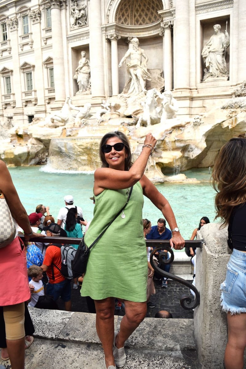 </who>Kerry MacNaull throws a coin over her shoulder into the Trevi Fountain to ensure a return trip to Rome.