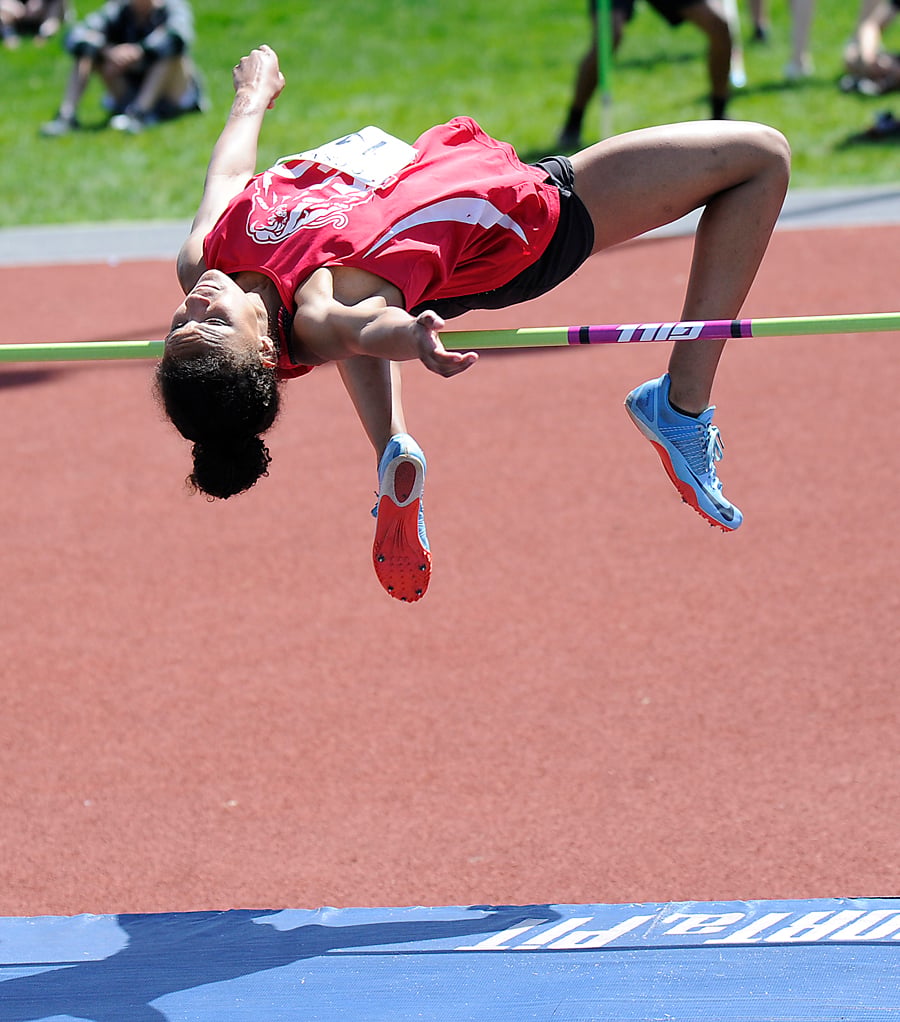 Mekhila Brown of KLO clears 1.60 metres to win the junior girls high jump.