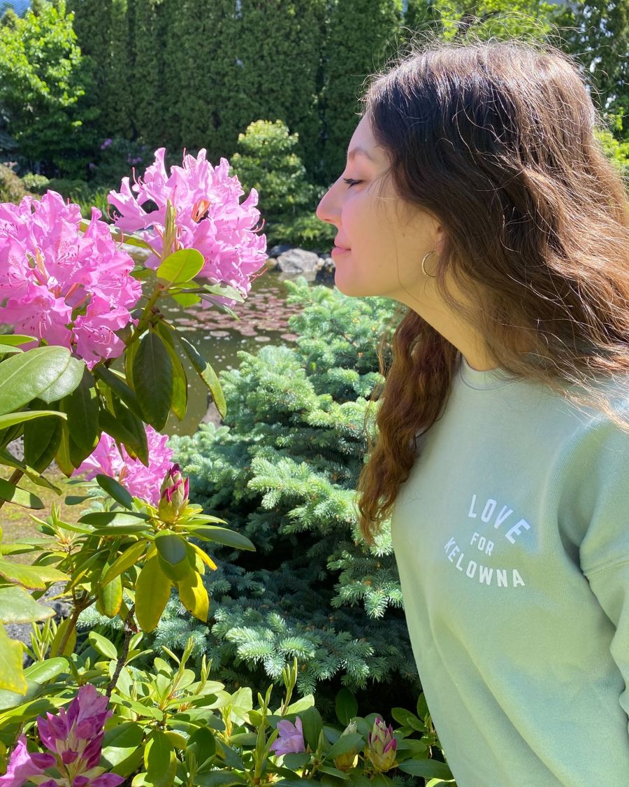 </who>Stopping to smell the flowers in a 'Love for Kelowna' sweatshirt.