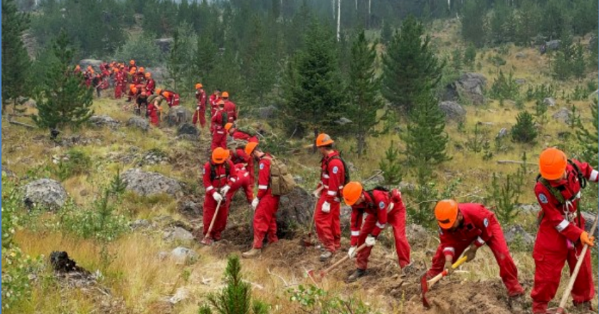 <who> Photo Credit: BCWS</who> Military personnel building a containment line on the Flat Lake wildfire on Aug.17