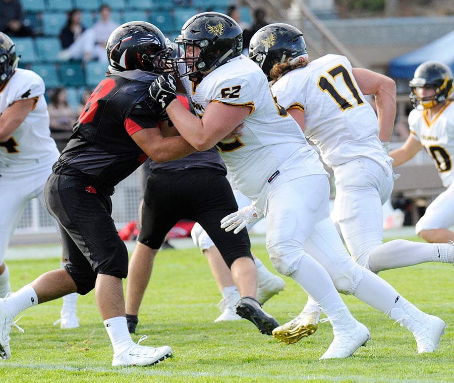 <who>Photo Credit: Lorne White/KelownaNow </who>Tomas Kuhn (62) battling in the trenches for the Owls against Abbotsford.