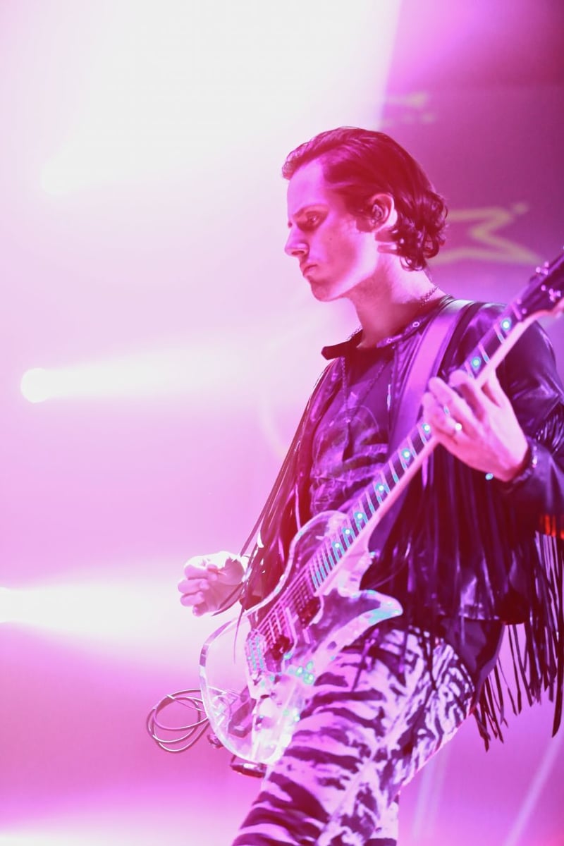 Lead guitarist Matt Webb basking in magenta light