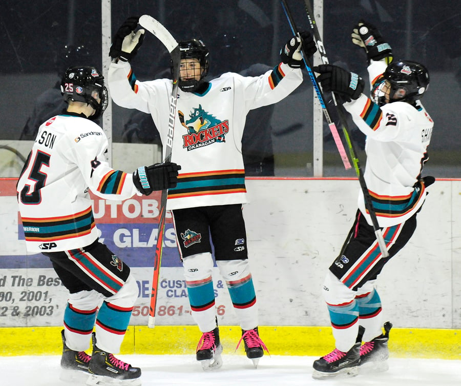 <who>Photo Credit: Lorne White/KelownaNow </who>Cameron Hicklin, centre, celebrates his first of two goals in the OK Rockets' overtime win at the CNC. Joining in are Brennan Nelson, left, and Riley Sharun.