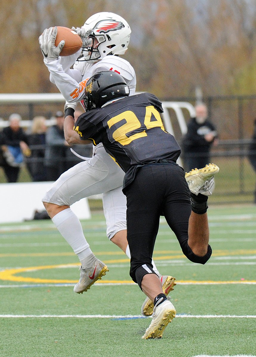 Jake Oseen of Carson Graham makes the catch but is brought down immediately by the Owls' Aidan Vint.