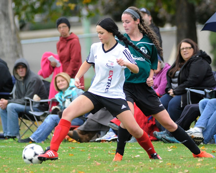 <who>Photo Credit: Lorne White/KelownaNow </who>Alexa Steele of the Rutland Canadian Tire Spirit, left, and Emily Spooner of West Kelowna Triumph Heating and Air Conditioning battle for possession during their U16A Kelowna Cup bronze-medal match at Parkinson Sportsfields on Saturday. West Kelowna won the game 1-0 on penalty kicks.