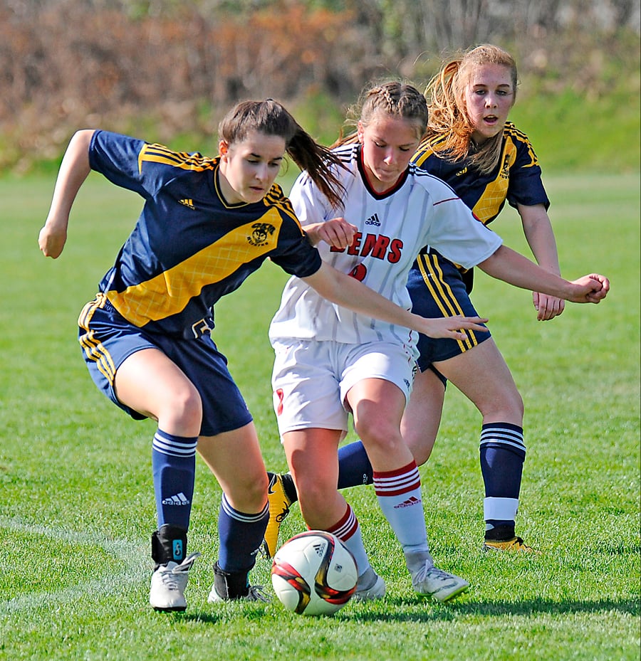 Mt. Boucherie's Dakota Fanning, centre, battles OKM's Melaina Corrado, left, and Devon Felts.