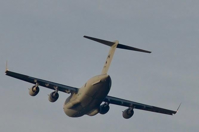 <who> Photo credit: Dave Pack </who> The CC-177 Globemaster III flying over Kelowna