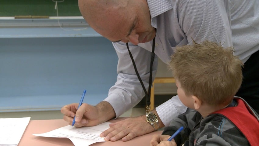 <who> Photo Credit: UBCO. </who> UBC's John-Tyler Binfet works with a student at a local elementary school.