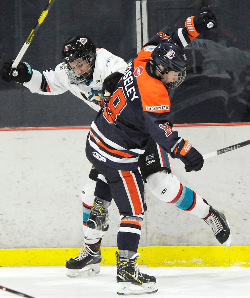Ty Marchant of the Rockets is pinned to the boards by the Thompson Blazers' Brendan Moseley.