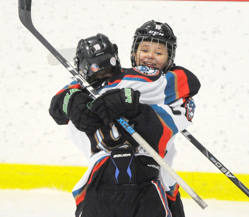 <who>Photo Credit: Lorne White/KelownaNow </who>Emmett Nordin (foreground) gives Maddix McCagherty a huge hug after the latter Rocket scored a first-period goal.