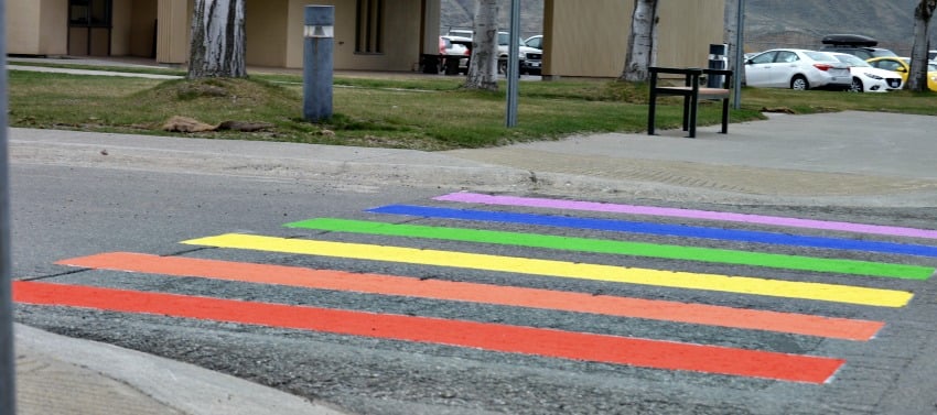 A second rainbow crosswalk painted next to the terminal.