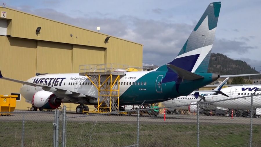 </who> A WestJet 737 Max 8 being maintained at Kelowna International Airport.